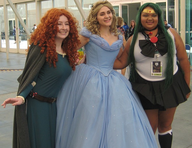 Cinderella posing with 2 other cosplayers