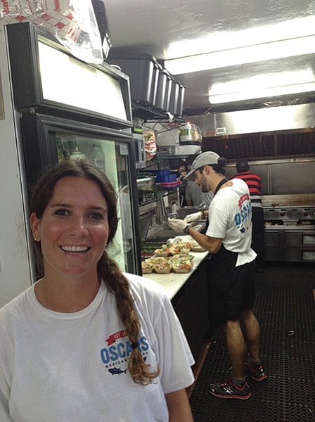 Gabriela at the order counter and the kitchen in action