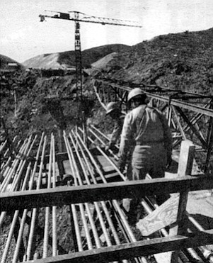 Hundred of threaded steel rods pre-stress the bridge (February '74).