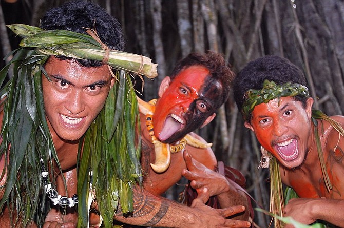 At the Kamuihei ceremonial site in Nuku Hiva, exuberant dancers pose after a riveting performance.