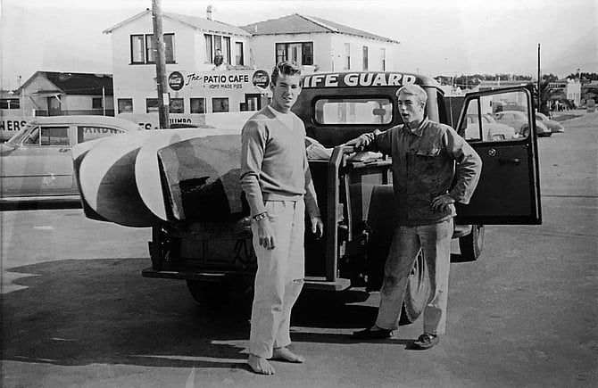 Lifeguards Chuck Quinn and Tom Carlin waiting to surf with Dempsey Holder. Winter, 1952, Imperial Beach