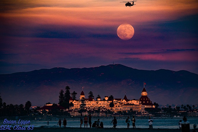 The full "Sturgeon Moon" with Otay Mountain in back of the Iconic Hotel Del Coronado. The sun was setting with the last rays of light for the on the Del. A Navy Helicopter from North Island was coming in to North Island..over Dog Beach....I could tell you what squadron but I'd have to kill you! 