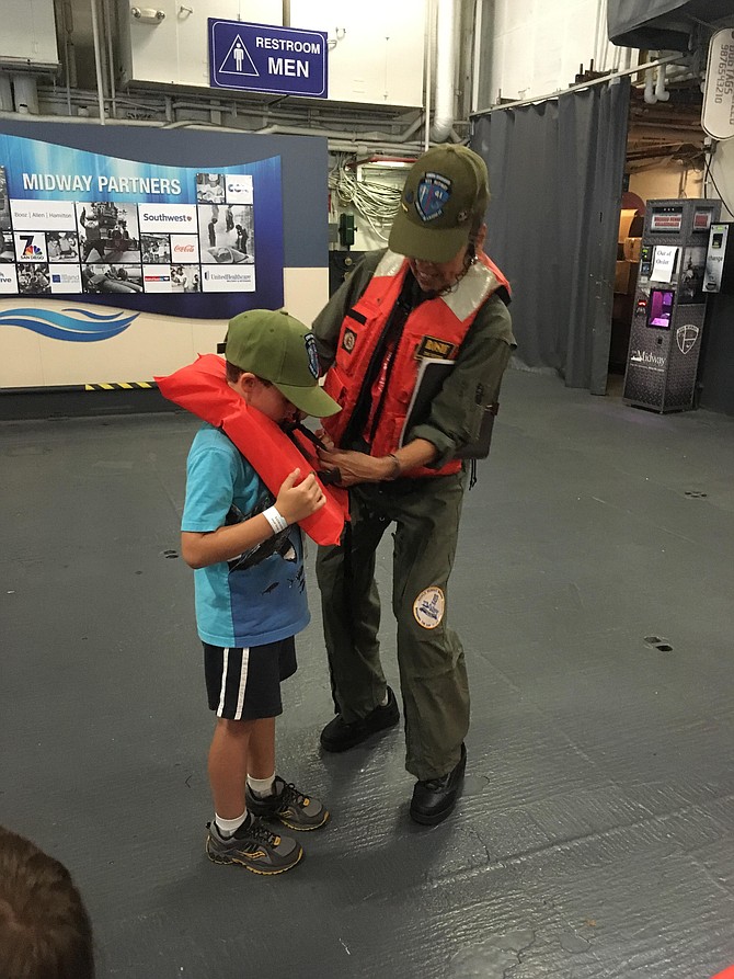 A little Skipper suits up to participate in lifeboat activity.