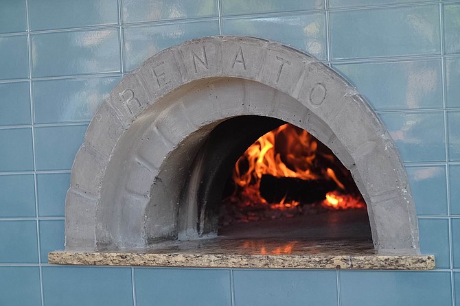 Tribute’s 1500-lb wood-fired Renato oven burns white oak and runs through a filtration system that converts smoke into harmless water vapor