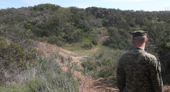 A Marine and a trail made by base intruders