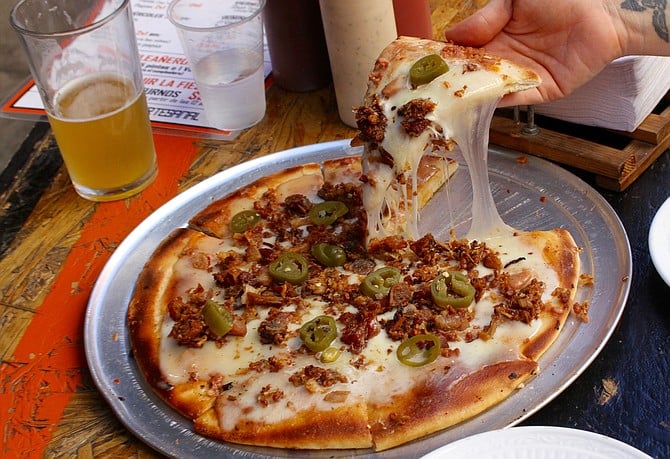 Chicharrón pizza with plastic-looking cheese