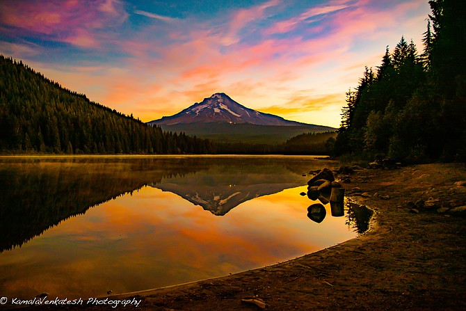 Mt. Hood reflected in the tranquil waters of Trillium Lake in Oregon.  Mt Hood at over 11,000 feet, is the tallest peak in Oregon and the fourth highest in the Cascade Range. Trillium Lake, is in the middle of the Mount Hood National Forest. The lake is a perfect mirror to see the reflection of the snow-covered Mt. Hood.  Many trails available for hiking and the lake provides great fishing. 