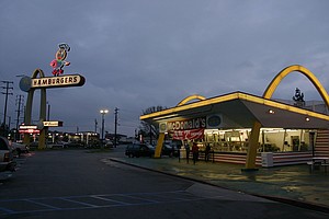 McDonald's in Downey, California.  Opened in 1953.  Red and white tiles, "golden arches" and Speedy the mascot introduced by Ray Kroc.