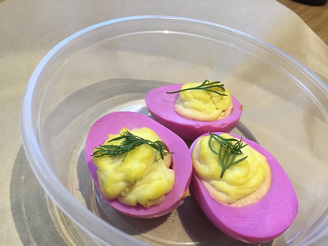 The deviled eggs are pickled in beet juice to add sweetness and this purplish color.