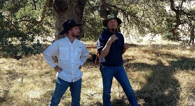 Kevin Muno (left) and John Wick discuss the implications of their composting experiment
