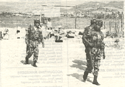 Mexican federales, soldiers in full uniform armed with rifles, patrolling the sand amongst the telescopes