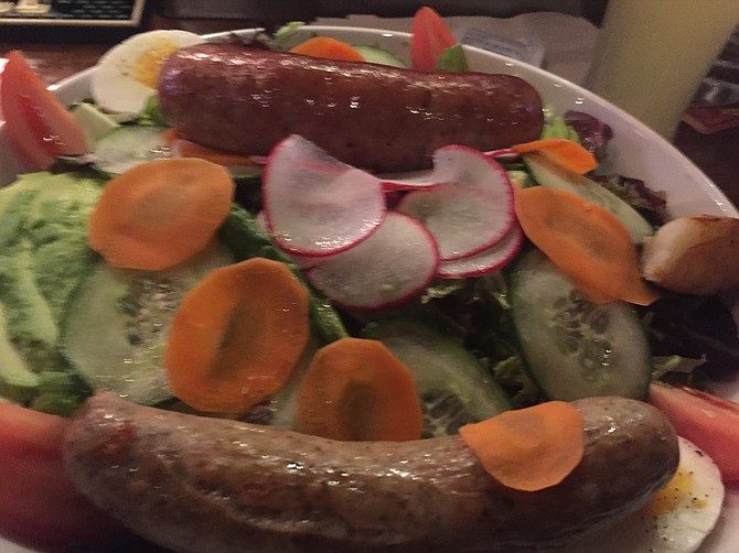 A fresh green salad with homemade andouille sausage (top) and spicy bratwurst with gouda sausage (bottom)