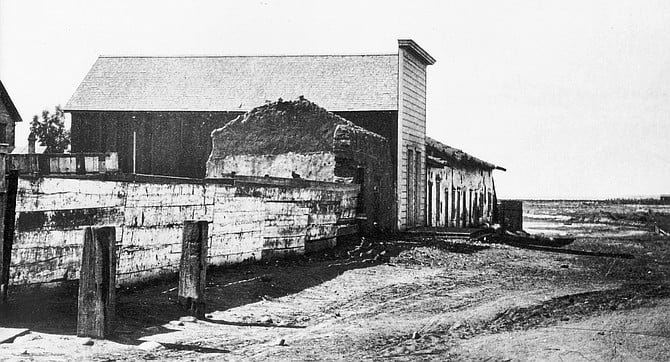 The first official schoolhouse — in District I — was the Fitch-Snook house on Calhoun Street. Rent was $14 per month. Class-work began August 1, 1854.