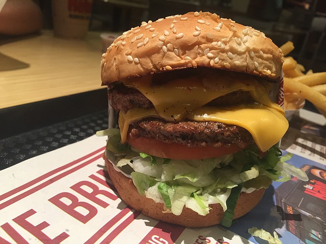 The Habit's double charburger has lettuce, tomato, mayo, caramelized onions and two beef patties. All on a sesame seed bun.