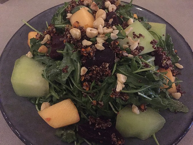 The Melon and Roasted Beet Salad has lots of arugula as well as chopped hazelnuts and red quinoa in a white balsamic vinaigrette.