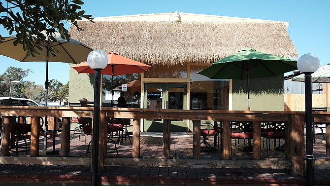 A thatched roof storefront and new deck grace Rock Steady Jamaican, formerly Island Spice Jamaican.
