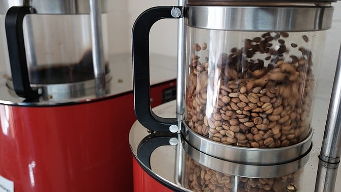Coffee beans are tossed and heated by hot air in a fluid bed roaster at David’s Roasting.
