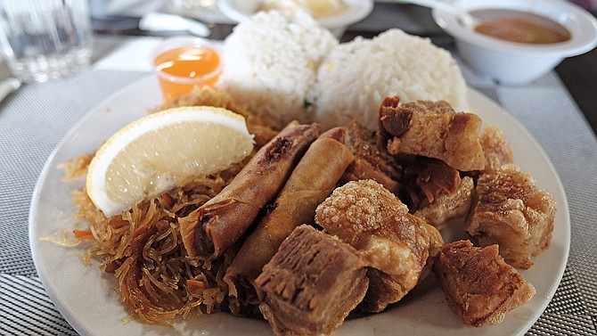 Crispy fried pork belly with lumpia, rice, pancit noodles, and Mang Tomas dipping sauce.
