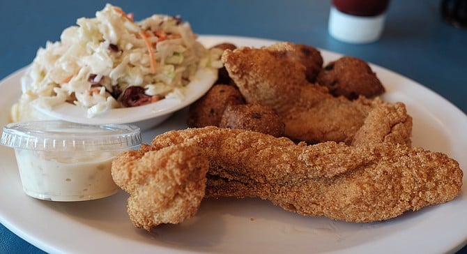 Fried catfish with a cornmeal crust plus hush puppies and coleslaw with diced cherries