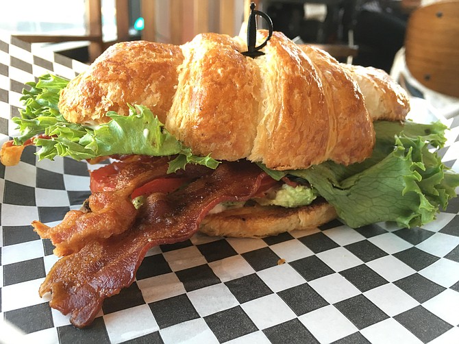 Just-right bacon on a toasted croissant with tomato and avocado. They call it a BLAT.