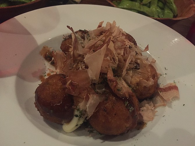 Takoyaki is a term for deep-fried octopus fritters served with mayo, brown sauce and topped with bonito flakes.