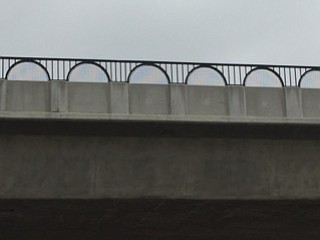 It's hard to see the black vinyl chain link fence used on this Oceanside bridge. 