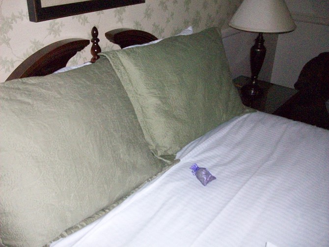 Lavender satchel placed on hotel bed nightly.