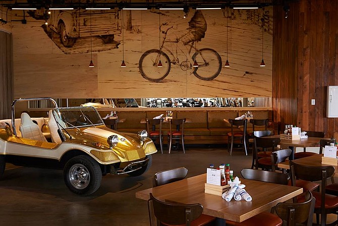 The dining room at Hello Betty has surfer vibes. Most patrons sit downstairs near the funky dune buggy.