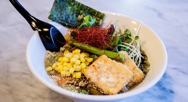 The vegan ramen comes with a variety of fresh veggies including corn, mushrooms, bean sprouts, and tofu.