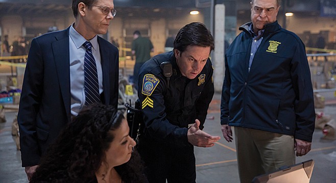 Patriots Day: John Goodman looks skeptical about the stopping power of Mark Wahlberg’s finger-gun; Kevin Bacon appears to be withholding judgment.