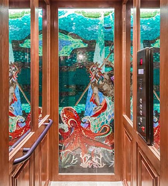 Mosaics are seen on every floor through the glass elevator