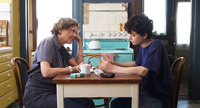 20th Century Women: Annette Bening waits patiently for Lucas Jade Zumann to comment on the juxtaposition of robin's egg-blue oven and avocado woodwork.