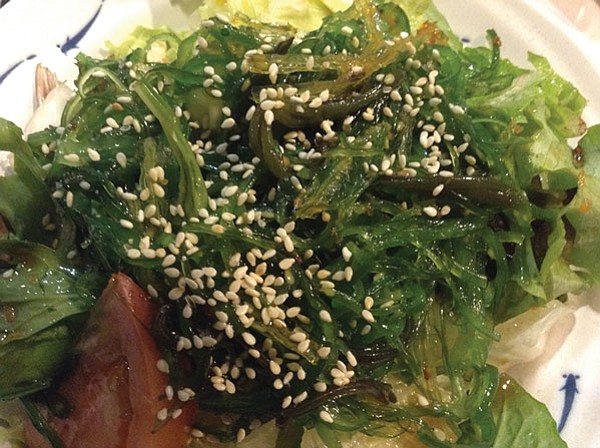Kanpai's seaweed sits on a pile of lettuce, showered with sesame seeds.
