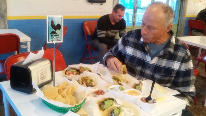 Ralph enjoys one of the many tacos on the menu.