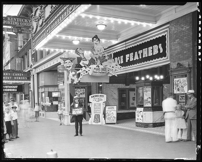 Establishing shot: EXT. KENTUCKY THEATRE LOBBY ENTRANCE AND TICKET BOOTH - DAY.