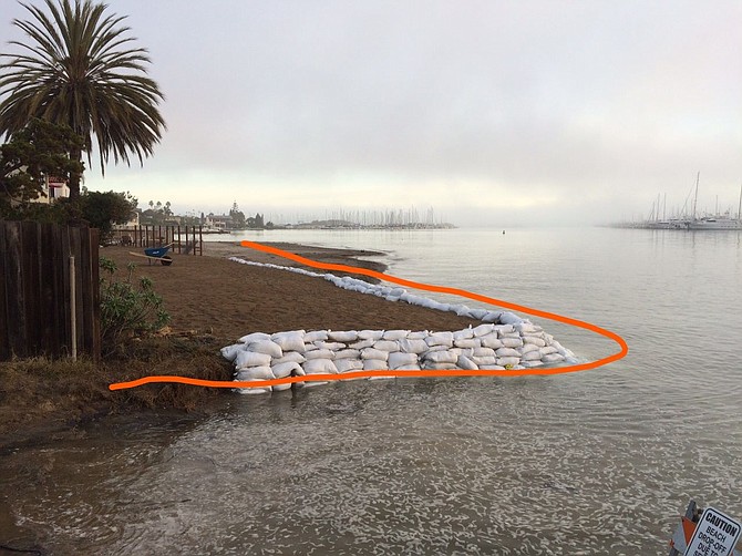 In early 2016, the developer brought in sandbags and infill to mark the property line. This would also be about where the proposed seawall would sit. The photo is at mid-high tide. At a true high tide, the water would be over the top of the sandbags. This was not done with permission and the city forced them to remove all of it.