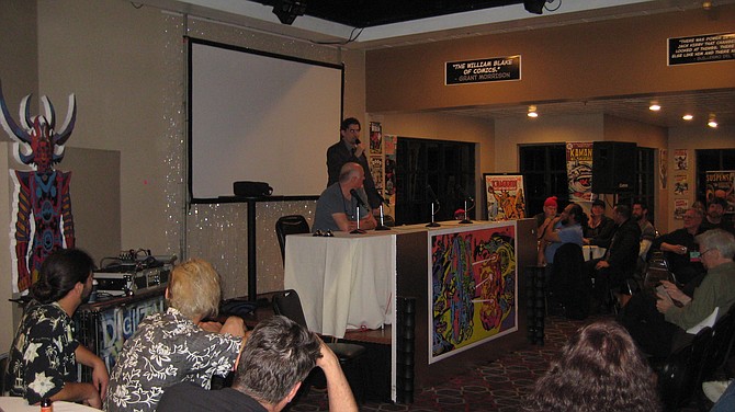 Mike Towry sitting in front of audience at Comic Fest Café