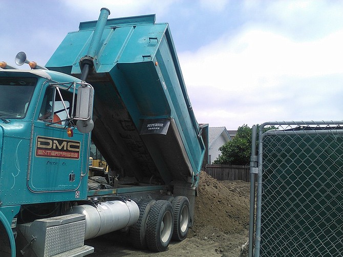 Dirt was dropped off in July 2016 to build up the grade on Garrison and Evergreen (one block over from Emerson/Evergreen).