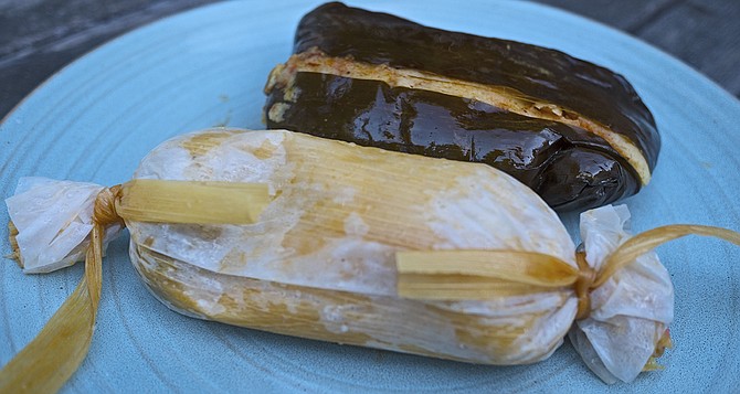 That's a corn husk tamal with pork in front, and an equally greasy chicken platano in the back.