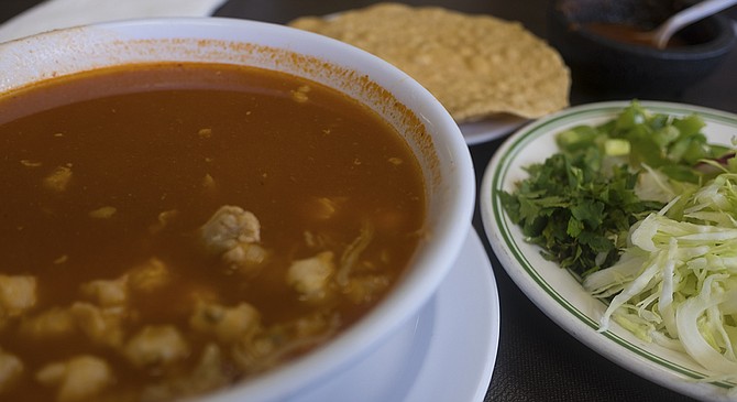 Pozole translates to hominy, derived from Aztec words describing it for what it is: a bunch of fluffy corn kernels