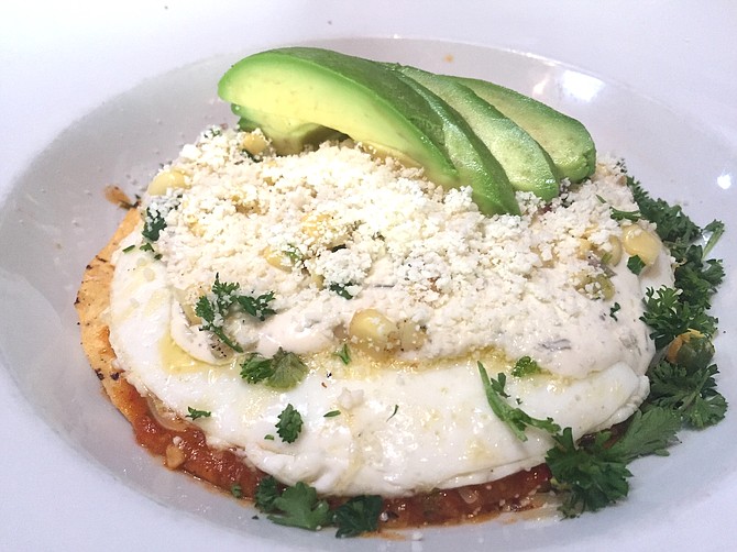 Chilaquiles, a tostada with eggs, cheese, salsa, cotija, and corn salsa. The corn was fresh, “really fresh.”