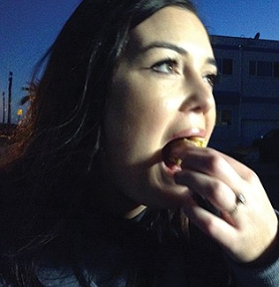 Michaela eats her first-ever hot dog