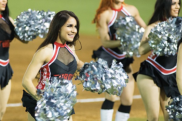 Scantily clad cheerleaders down the foul lines bump and grind during game pauses.