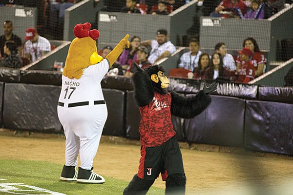 Mascots Pollo Layo (a chicken), Chango 0Te (a monkey) start by throwing bananas into the crowd.