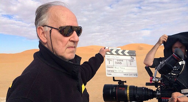 Herzog in the desert, directing his Queen.