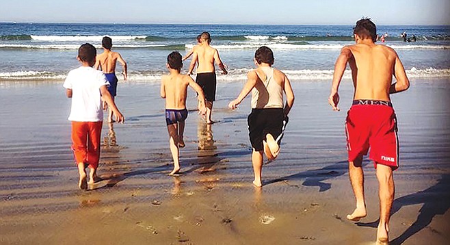 Refugee children on their first ever beach outing. The scene is deceiving, says Kristin Burke: What El Cajon-based refugees have compares poorly to what’s available to Atlanta refugees. - Image by Kristin Burke