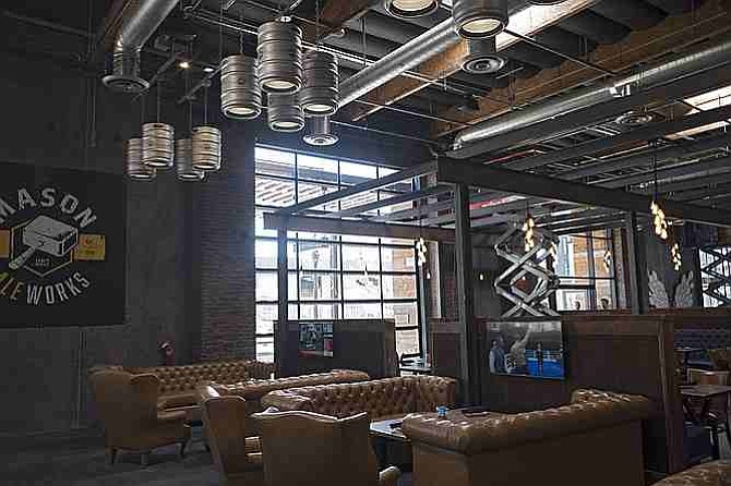 Fixtures at Urge Common House include couch seating and personal TVs, and lighting made from kegs.