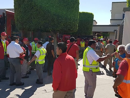 Workers and firefighters outside plant (Photo: El Sol de Tijuana)