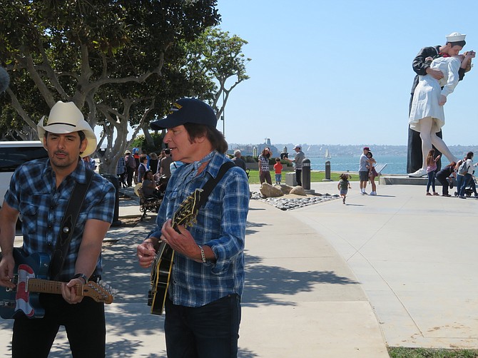 Brad Paisley and John Fogerty perform their music video "Love and War" with "Unconditional Surrender" and USS Midway in the background