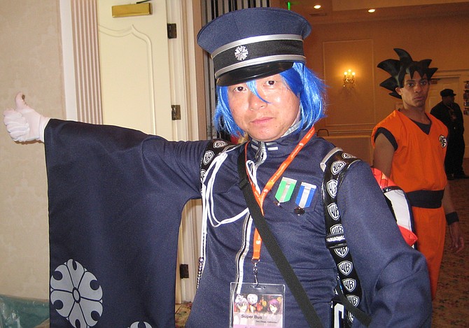 Peter Lau as Kaito Senbonzakura from Vocaloid. Dragon Ball Z cosplayer is in the background